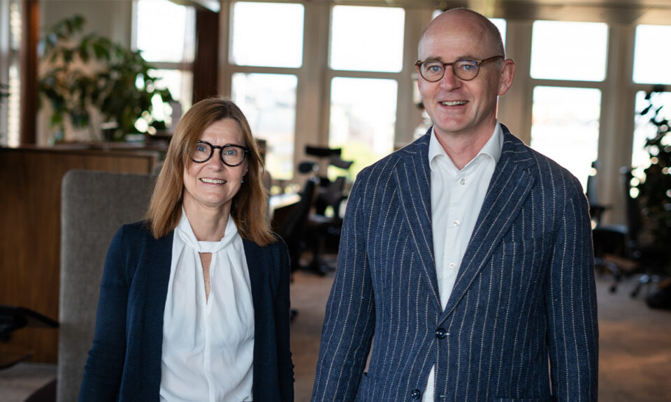 Helena Engner Aili och Klas Lindgren Dansbo står bredvid varandra på SEK:s kontor i Stockholm.
